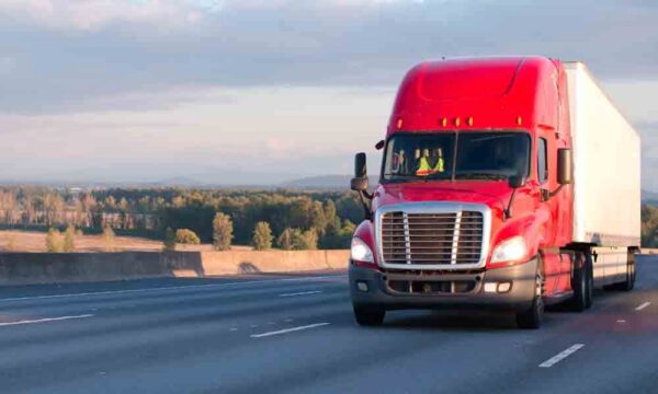 tractor trailer driving down highway