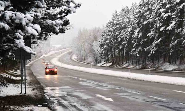 cars driving down winter road