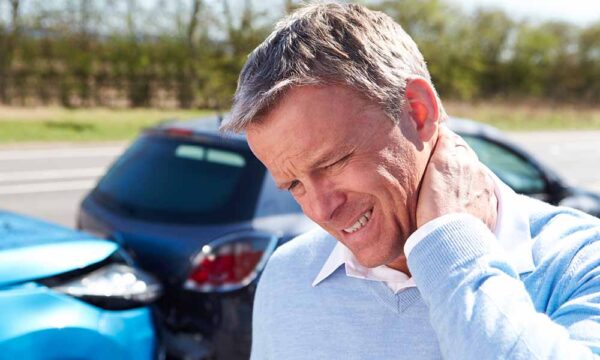 man in pain holding neck