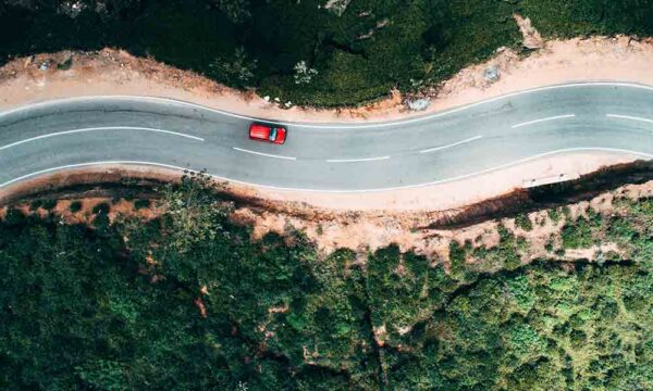 bird's eye view of a car driving down winding roadway