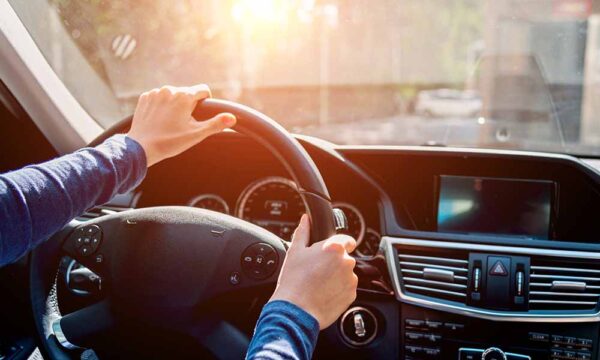 teenage driver with hands on steering wheel