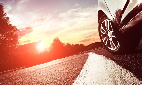 closeup of a car's side driving down a road