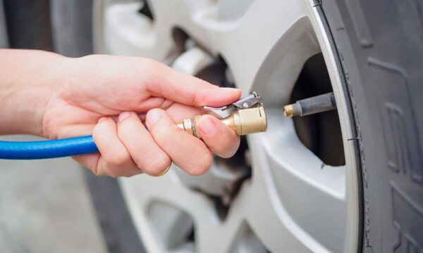 Person putting air in their tire