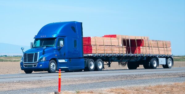 Flatbed truck driving along road