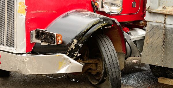 Red semi truck with a tire blowout