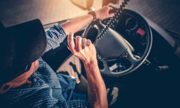 truck driver talking into truck radio