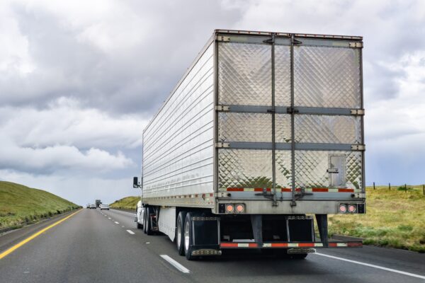 View of large commercial tractor trailer truck blind spot on highway