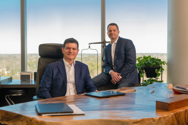 Fried Goldberg LLC attorneys posing at their office desk