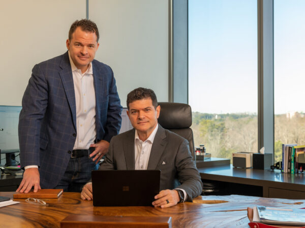 Fried Goldberg Attorneys posing at their office desk