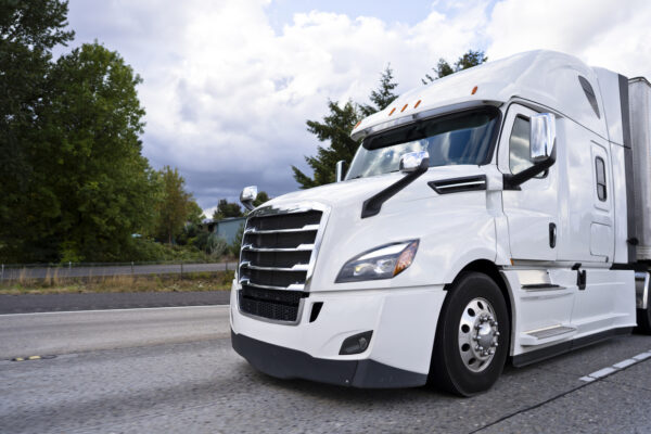 White semi truck rig running on divided highway in Georgia